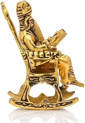 Side view of the golden Ganesha idol on a rocking chair, holding the Ramayan, ideal for gifting or decoration.