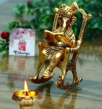 Golden Ganesha idol reading Ramayan on rocking chair – spiritual home decor